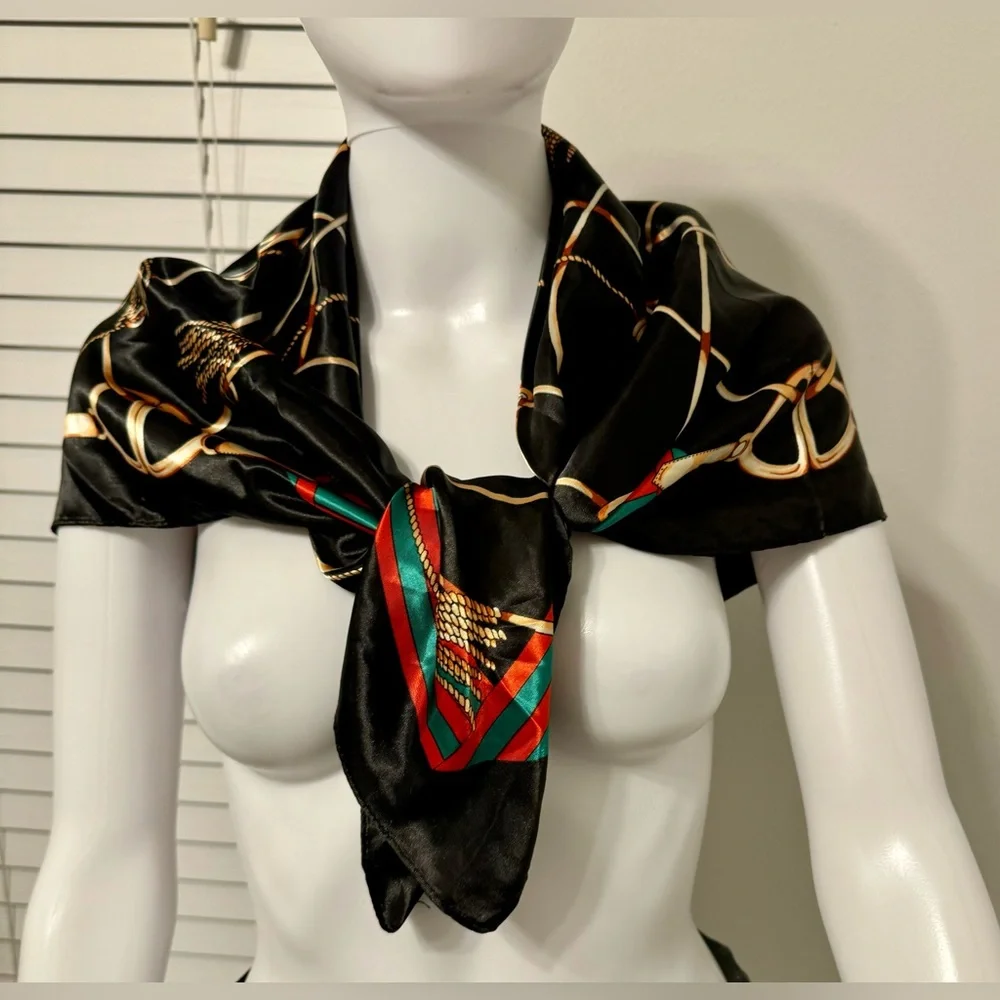 Fashionable women's black scarf with a chain and print. Polyester.
